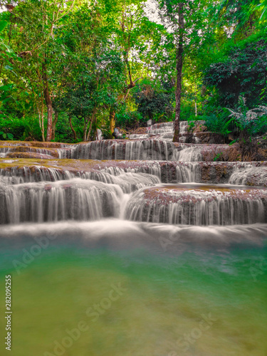 Fototapeta Naklejka Na Ścianę i Meble -  soft water of the stream in the natural park, Beautiful waterfall in rain forest ( Maekae Waterfall, Thailand)