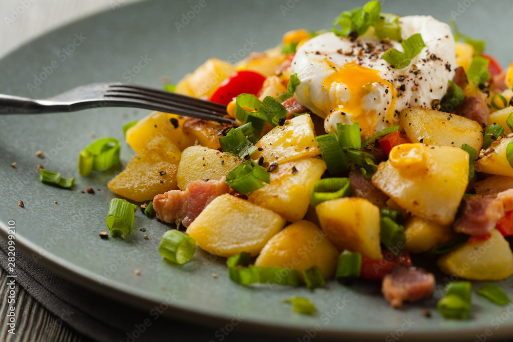 Traditional American hash with fried eggs. Front view. Traditional American hash with fried eggs. Front view.
