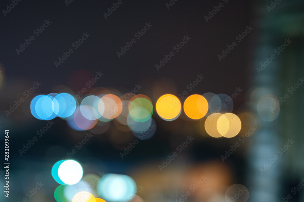 Abstract urban night light bokeh defocused background with sky space area