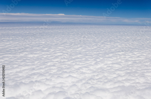 Blue sky and silky white clouds with impressive shapes, views over the heights © Toni