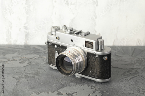 The old rangefinder film camera with on grey cement background. photo