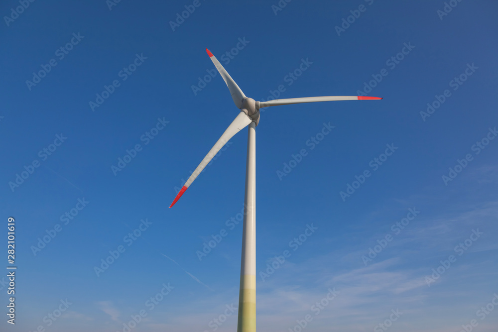 wind turbine with sun flare blue sky background view from below wind turbine with sun flare blue sky background view from below
