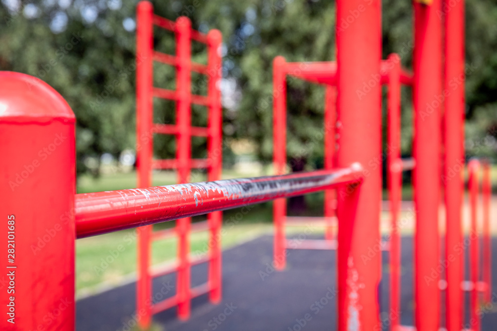 Red gymnastic bars outdoors, open-air gym Red gymnastic bars outdoors, open-air gym