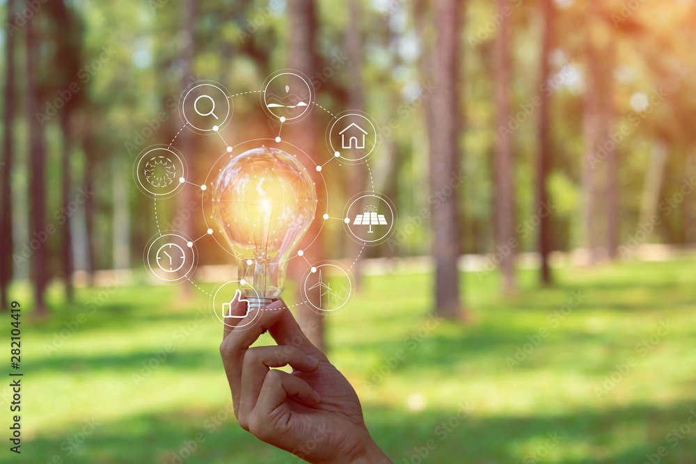 ้hand holding light bulb against nature, icons energy sources for renewable, ้hand holding light bulb against nature, icons energy sources for renewable,