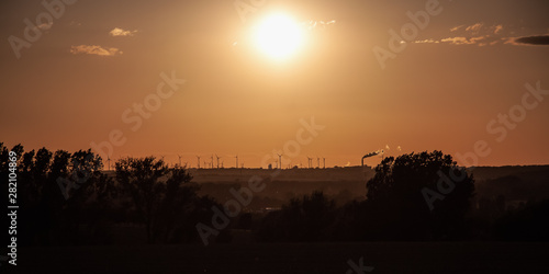 Wind turbines on the horizon as the sun goes down
