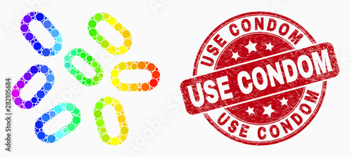 Pixelated rainbow gradiented microbes mosaic pictogram and Use Condom stamp. Red vector round scratched stamp with Use Condom phrase. Vector collage in flat style.