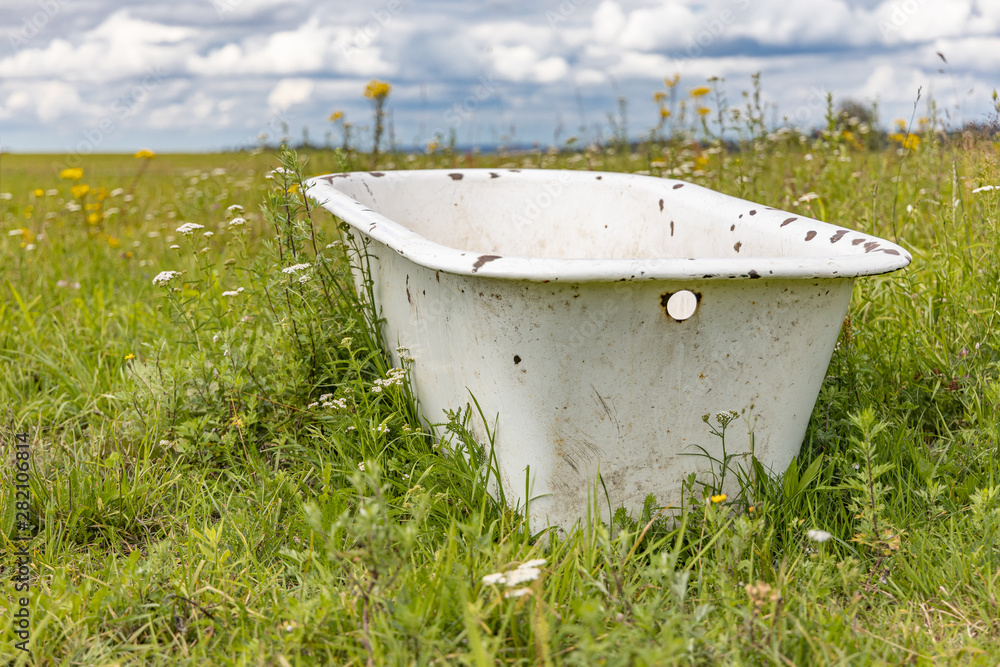Old bath tube in the middle of the meadow. Old bath tube in the middle of the meadow.