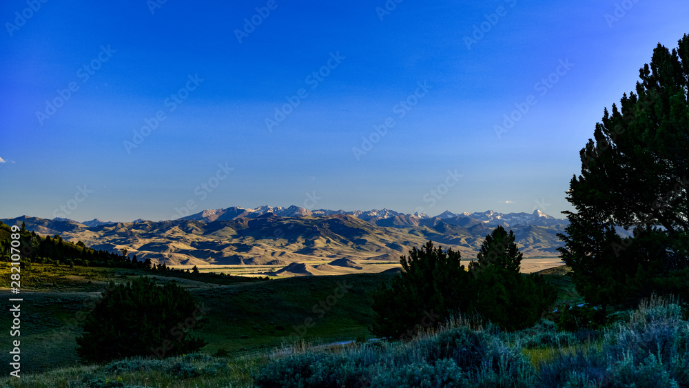 Many tall mountain peaks in a range in Idaho across a wide valley