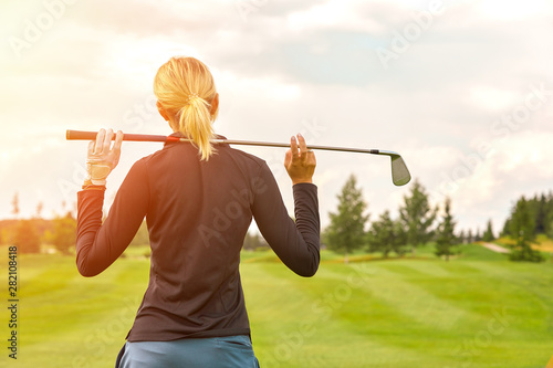 Goal concept, copy space. Women golfing time holding golf equipment on green field background. The pursuit of excellence, personal craftsmanship, royal sport, sports banner.
