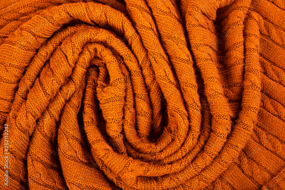 Fototapeta premium Crumpled knitted blanket. Soft and warm fabric crumpled in folds. Texture for background or illustrations.