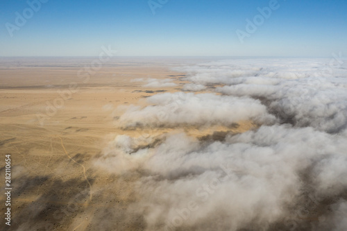 Coastal fog rolling over the desert landscape of Skeleton coast. Skeleton coast, Namibia. © Kertu