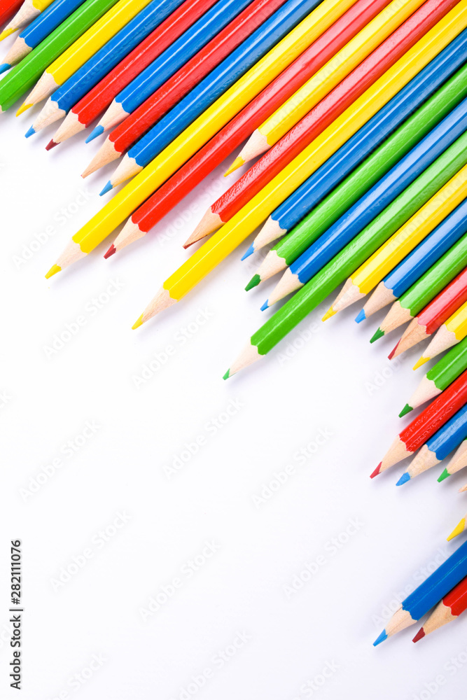 Fototapeta premium Many different colored pencils on a white background with a place for text and cory space .