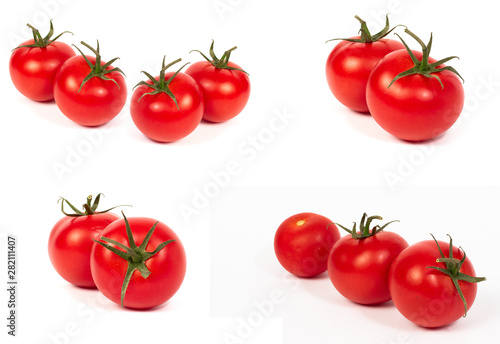 Red tomatoes on a white background. A group of tomatoes with herbs on a white background.