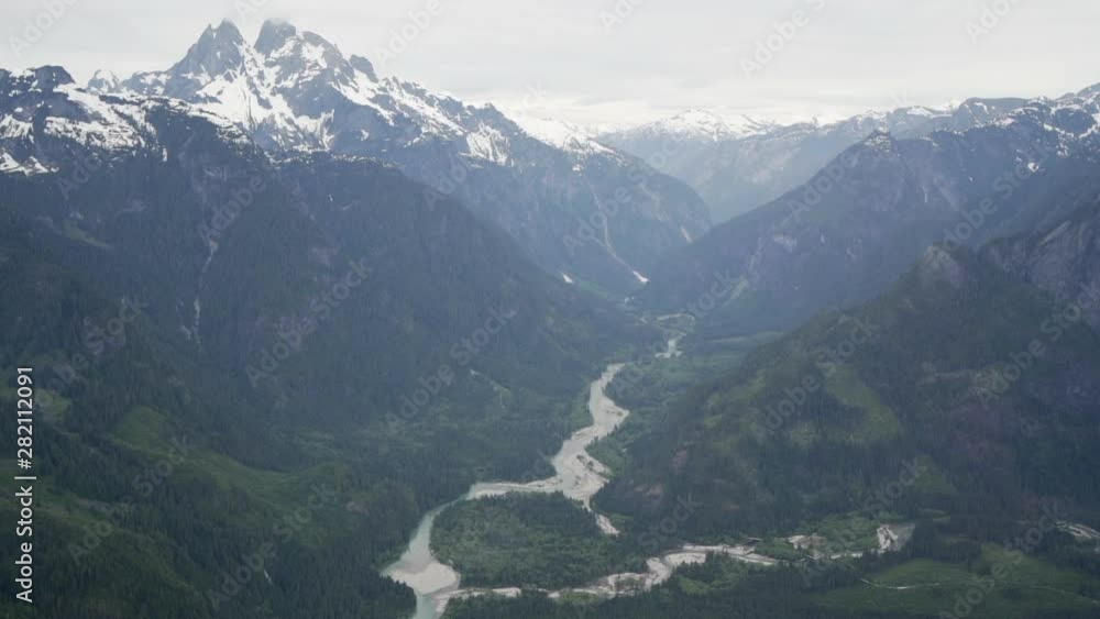 Aerial: Beautiful River Among Stunning Snowy Mountains and Pine Forests in Vancouver, Canada Aerial: Beautiful River Among Stunning Snowy Mountains and Pine Forests in Vancouver, Canada