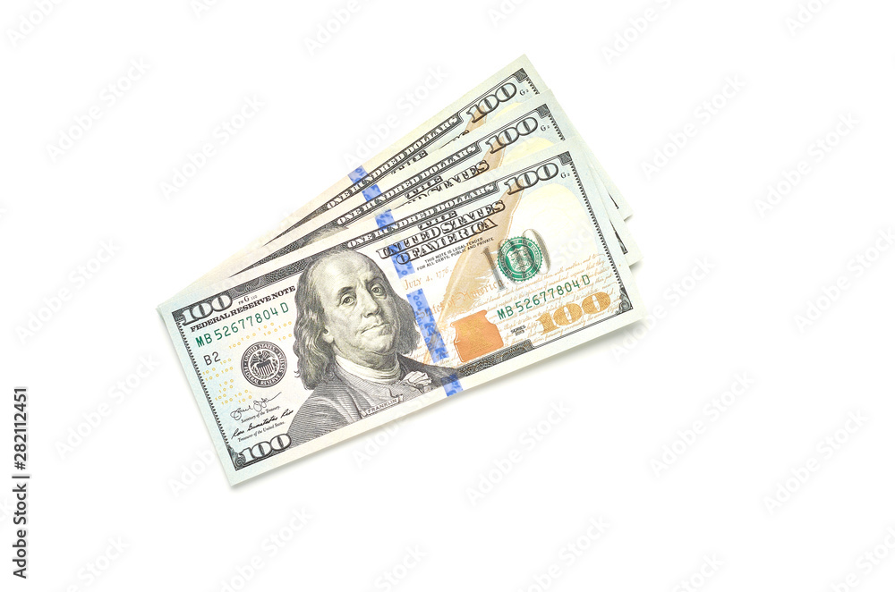 Three hundred dollars in bills of one hundred dollars lie on a white background. The view from the top. Three hundred dollars in bills of one hundred dollars lie on a white background. The view from the top.