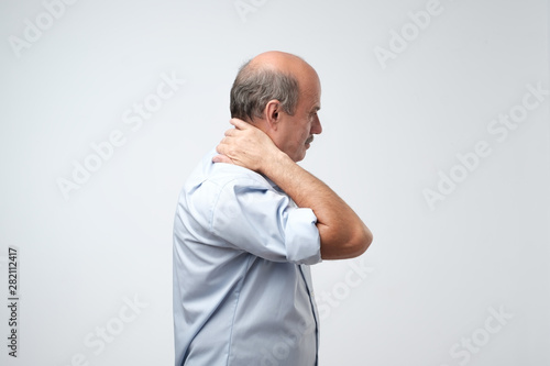 Old hispanic man with neck pain because of injury or hernia © Viktor Koldunov