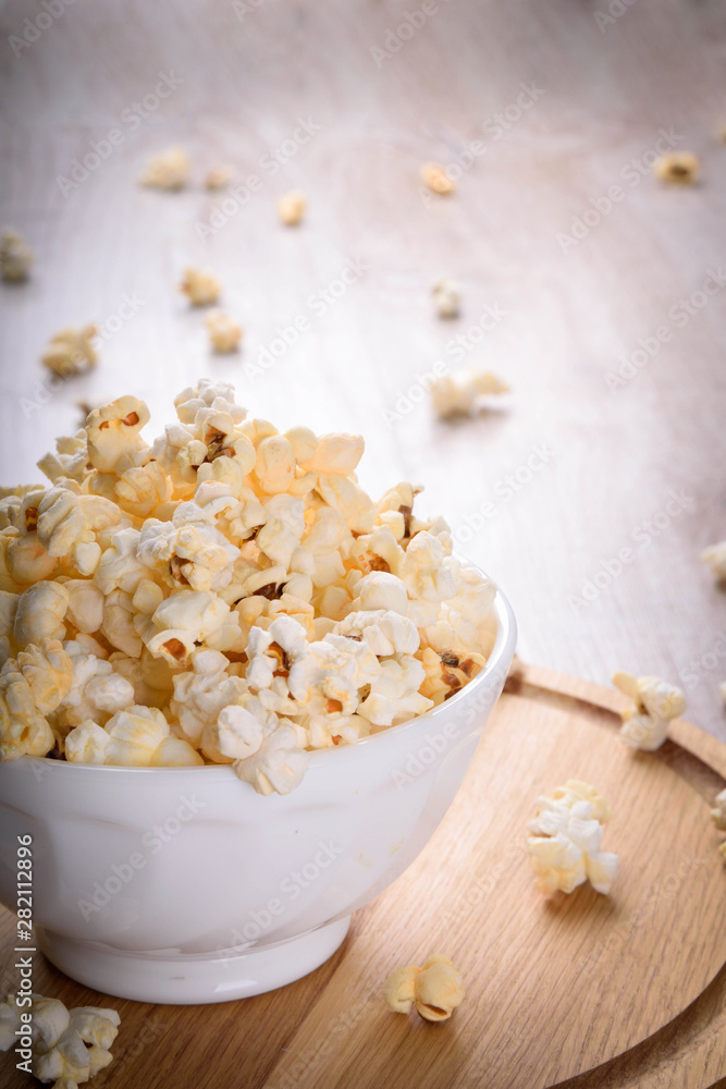 Salt popcorn on the wooden table, selective focus Salt popcorn on the wooden table, selective focus