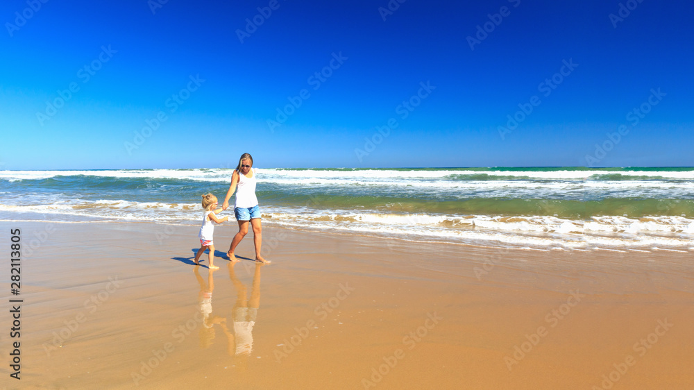 Happy mother and daughter spend their holidays on the seashore. Happy mother and daughter spend their holidays on the seashore.