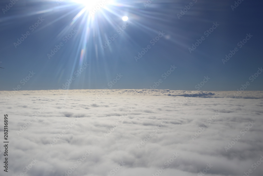 bright sunbeams flying sky above the clouds