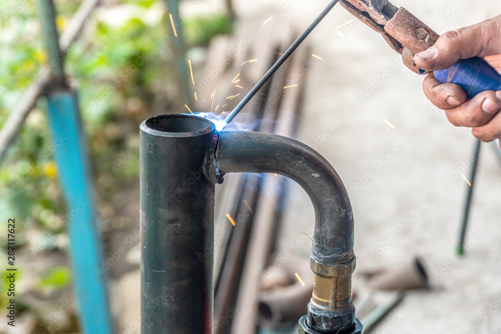 Worker cooks the heating pipe, welding joint. Preparing for winter heating. Worker cooks the heating pipe, welding joint. Preparing for winter heating.