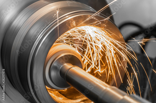 Bild auf Leinwand grinding metal on the machine, abrasive stone on the rim with sparks