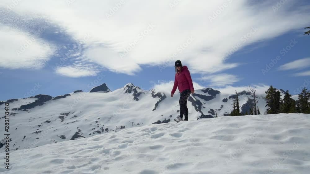 Slow Motion: Happy Young Woman in Beautiful Snowy Landscape on a Sunny Day in Vancouver, Canada Slow Motion: Happy Young Woman in Beautiful Snowy Landscape on a Sunny Day in Vancouver, Canada