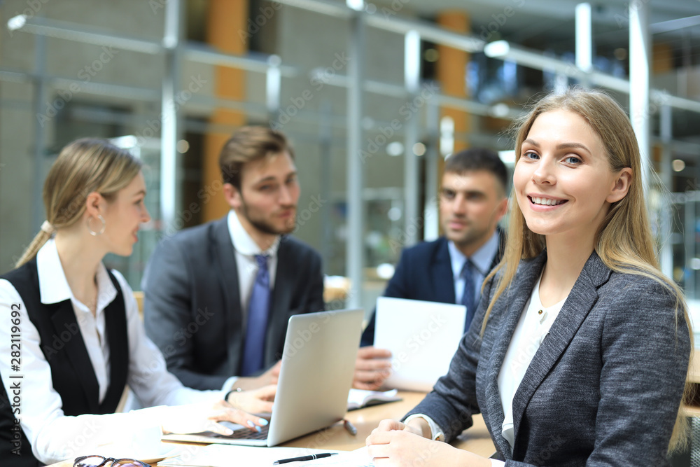 business woman with her staff, people group in background at modern bright office indoors. business woman with her staff, people group in background at modern bright office indoors.