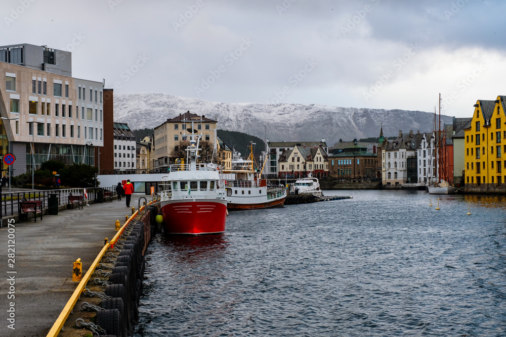 Obraz premium View of center of Alesund, Norway during the winter. Cloudy sky