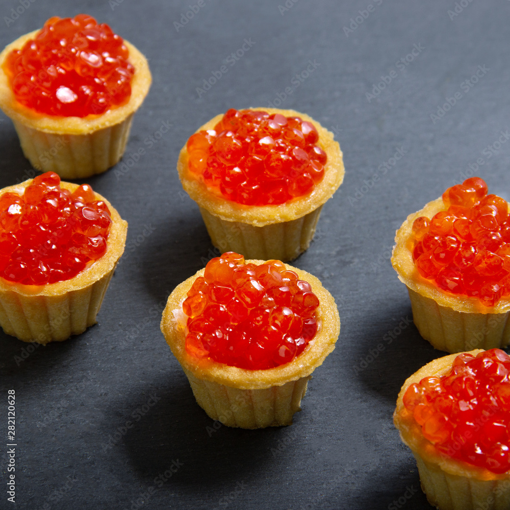 Tartlets with red caviar. Selective focus, space for text . serve red caviar Tartlets with red caviar. Selective focus, space for text . serve red caviar