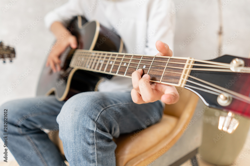 European male posing with acoustic guitar in his hands