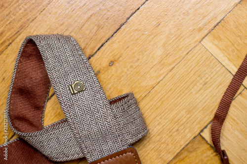 Vintage camera strap with camera icon placed on the left side