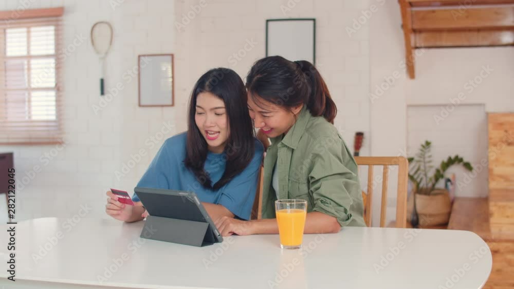 Asian Lesbian lgbtq women couple have breakfast at home, Young Asia lover female feeling happy drink juice, corn flakes cereal and milk in bowl on table in kitchen in the morning concept. Asian Lesbian lgbtq women couple have breakfast at home, Young Asia lover female feeling happy drink juice, corn flakes cereal and milk in bowl on table in kitchen in the morning concept.