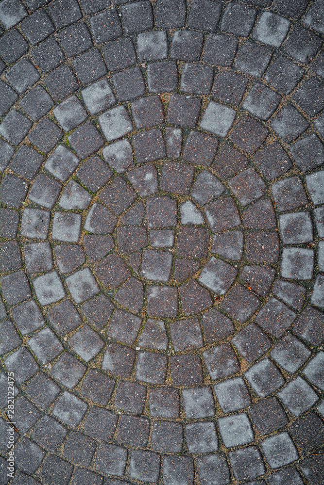 Circular texture of square stone floor. Urban cobble paving laid out of circles Circular texture of square stone floor. Urban cobble paving laid out of circles