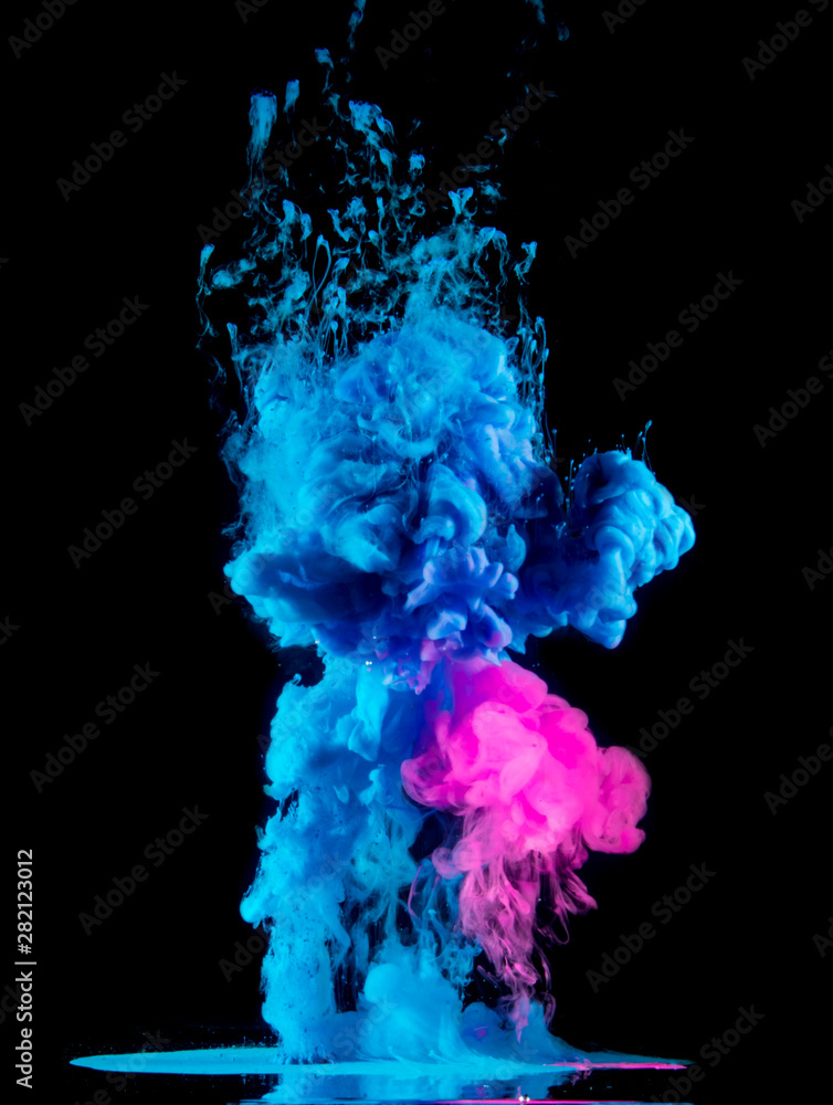 Paint drops from above mixing in water. Ink swirling underwater. Pink, blue colors