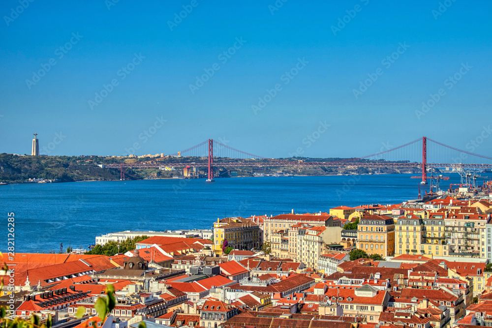 Views of Lisboa where you can see the roofs of their houses, Tajo River, April 25 bridge and Cristo Rey