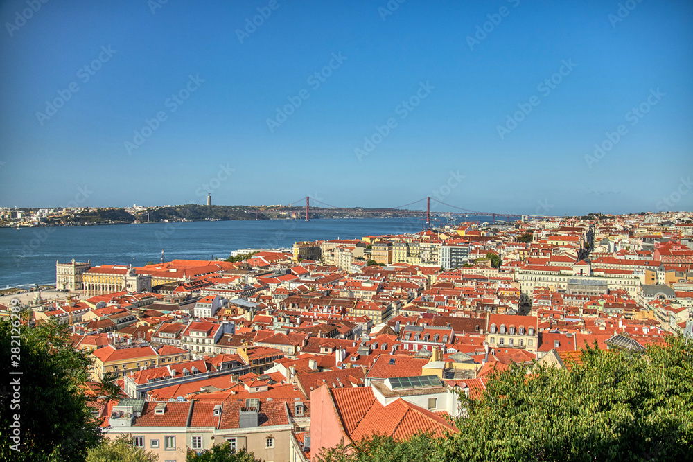 Views of Lisboa where you can see the roofs of their houses, Tajo River, April 25 bridge and Cristo Rey