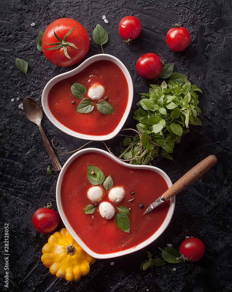 Cold tomato summer vegetable soup Gazpacho in a bowl in the shape of a heart. Vegetarian cuisine. The view from the top. The concept of healthy eating. Cold tomato summer vegetable soup Gazpacho in a bowl in the shape of a heart. Vegetarian cuisine. The view from the top. The concept of healthy eating.