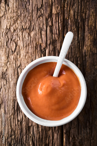 Slika na platnu Homemade fry sauce made of ketchup and mayonnaise in bowl with spoon, photograph