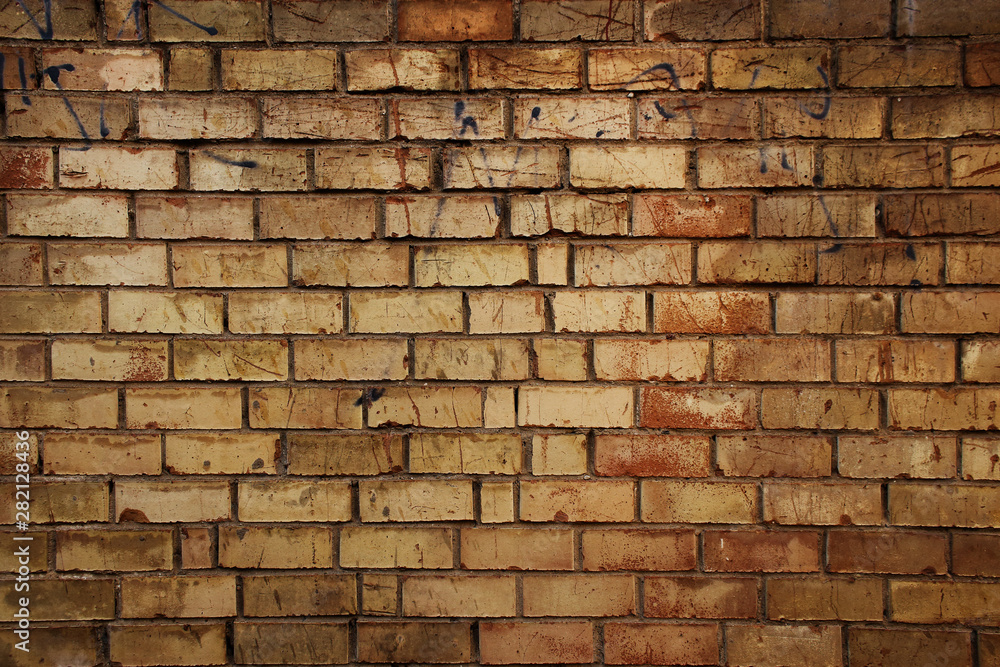 Fototapeta premium Old yellow brick wall background with natural vignette