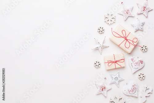 Christmas composition. Wooden decorations, stars on white background. Christmas, winter, new year concept. Flat lay, top view, copy space. © gitusik