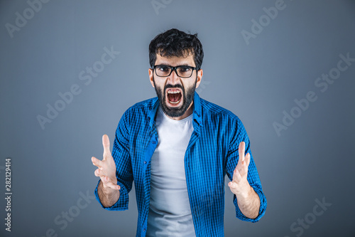 angry man shout on gray wall background