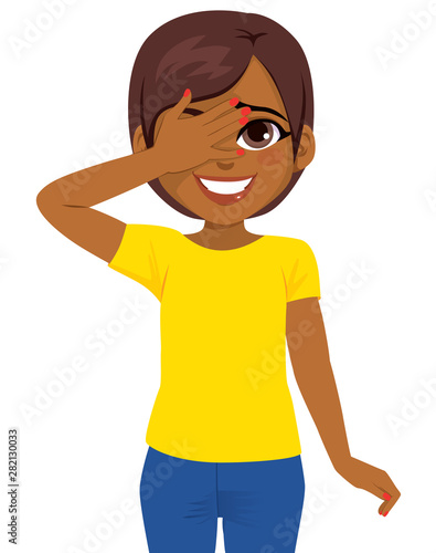 Beautiful young African American teenager woman hiding face behind hand. Shy face expression concept