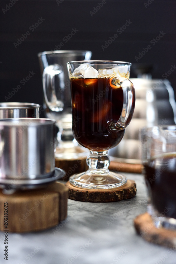 Making Vietnamese black drip ice coffee in irish mug on black background Making Vietnamese black drip ice coffee in irish mug on black background