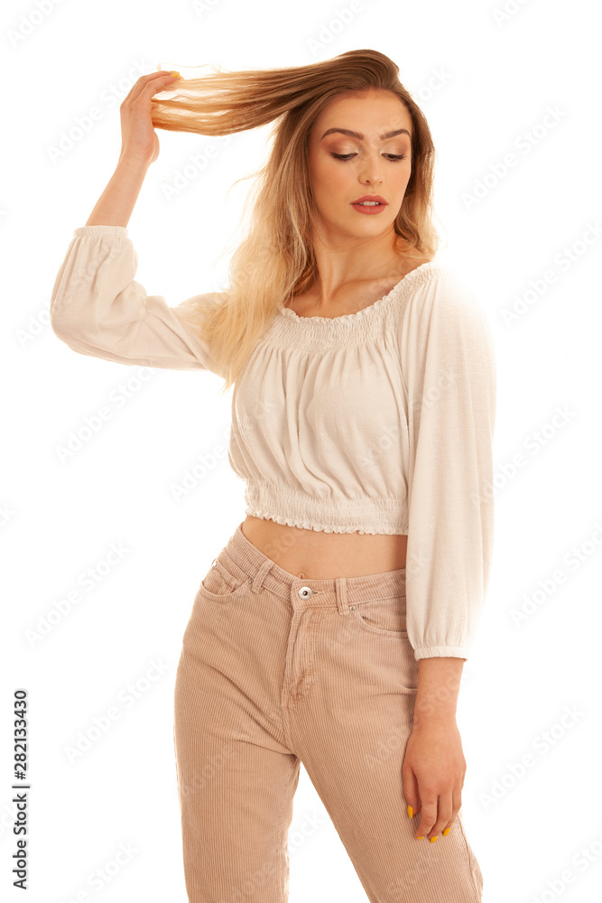 Fototapeta premium Beautiful young happy woman stands over white background gesture strong hair