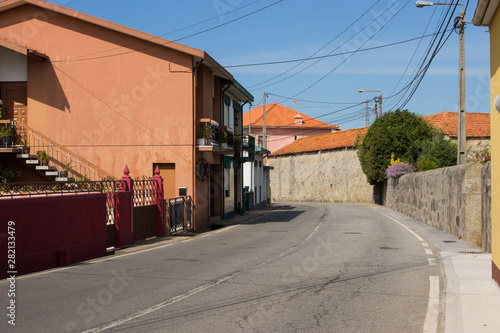 Portugal, unknown village - 06/10/2018: road in small portuguese village with old buildings. Travel in Europe. Rural landmark. Traditional spanish and portuguese house exterior. Summer tourism concept