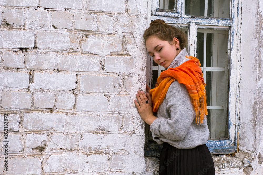 Young woman with orange scarf on white background
