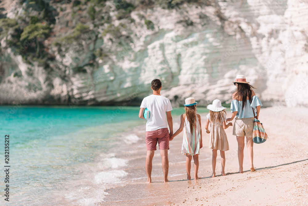 Photo of happy family having fun on the beach. Summer Lifestyle