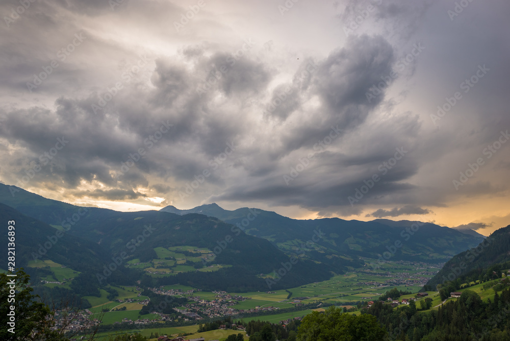Fototapeta premium Storm clouds gather over the mountains in Tirol, Austria at sunset