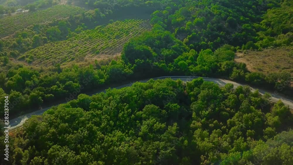 Drones Eye View - winding road from the high mountain pass to Crimea. Great road trip. Drones Eye View - winding road from the high mountain pass to Crimea. Great road trip.