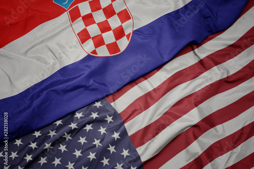waving colorful flag of united states of america and national flag of croatia.